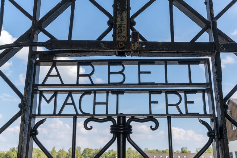 Dachau Germany historic entrance gate at concentration camp memorial near Munich with watchtower