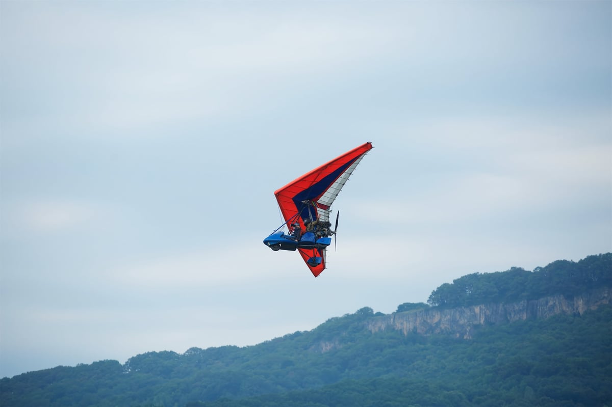 Hang gliding on the background of mountains and blue sky