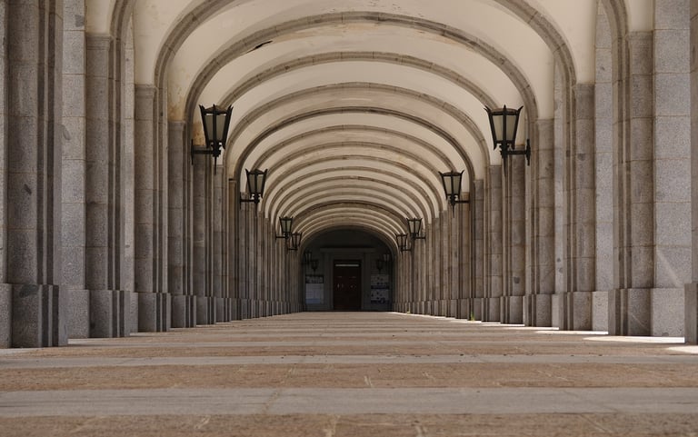 Paris Latin Quarter - Stone arcade with arches and vintage lanterns representing the Sorbonne area