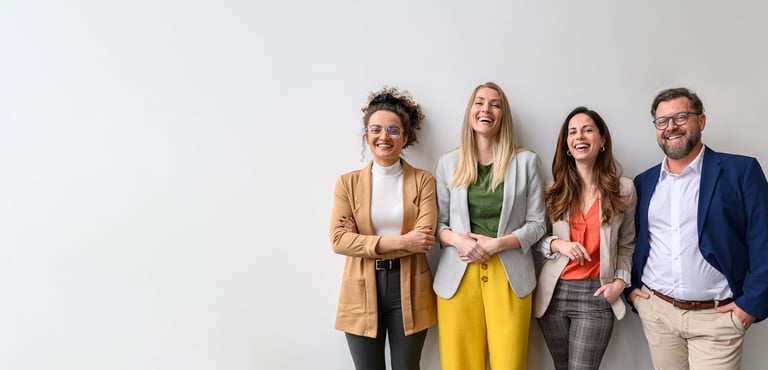 Portrait of smiling male and female business professionals standing and posing together