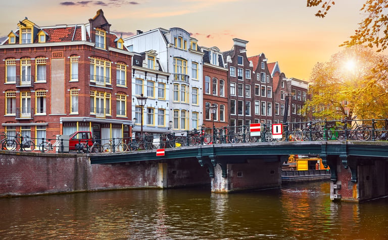 Traditional Dutch dancing houses on river Amstel in Amsterdam
