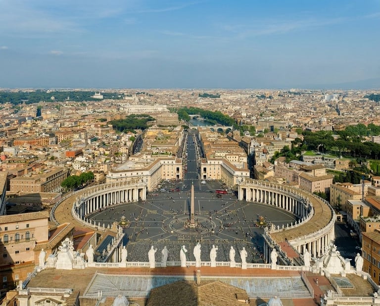 Aerial view of St. Peters Square in Vatican City with colonnade, plaza, and Rome cityscape beyond