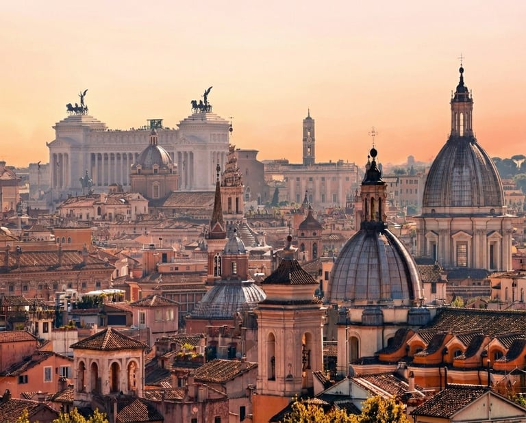 Rome skyline at sunset with historic domed churches, terracotta roofs, and the Victor Emmanuel II monument