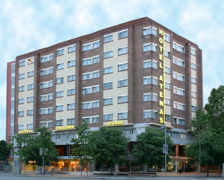 Modern brown and beige residential apartment building with ground floor shops and yellow storefront signage
